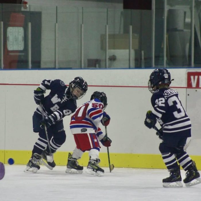 Junior hockey player hitting