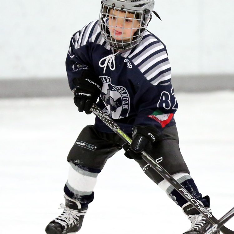 A junior player playing in the ice rink
