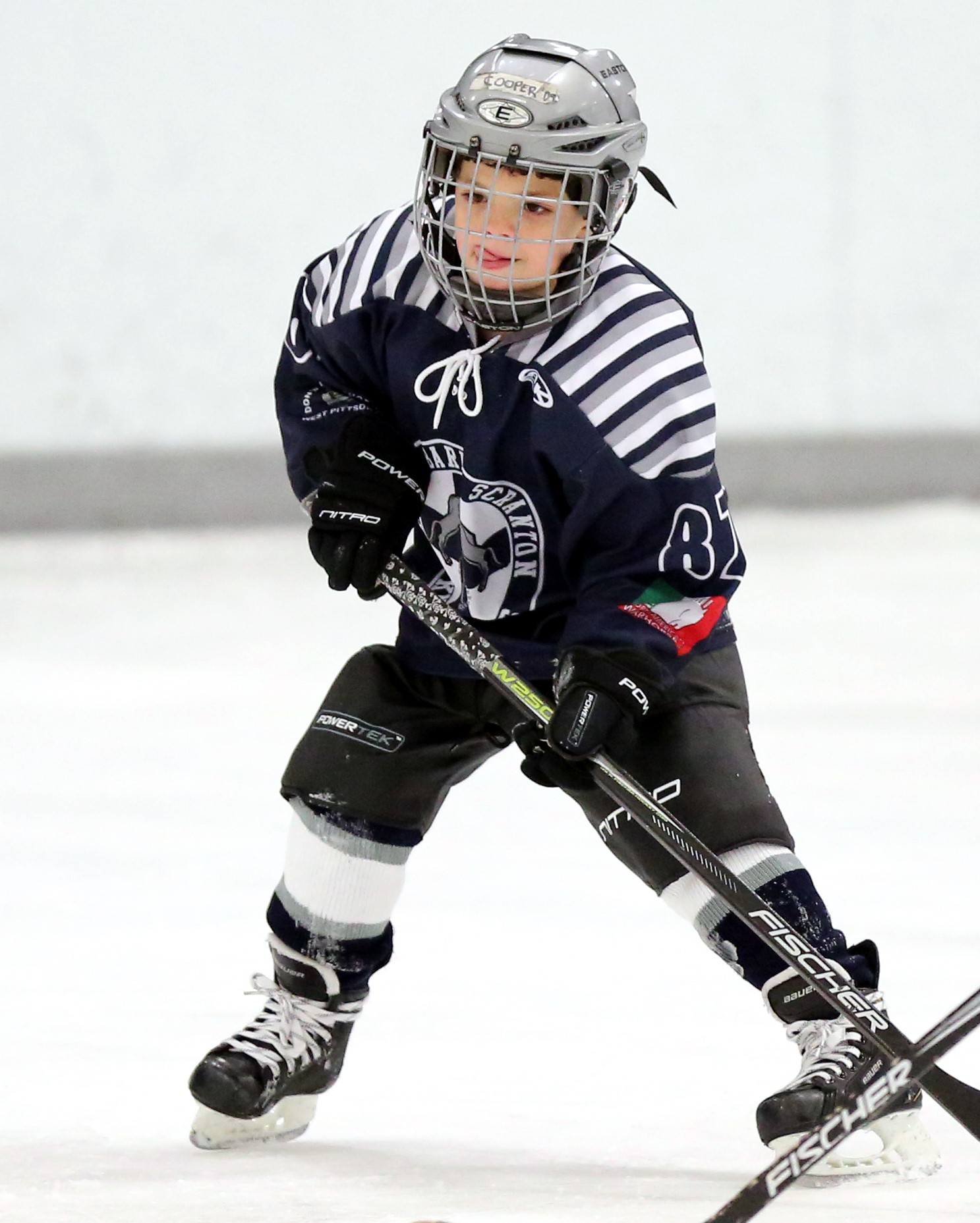 A junior player playing in the ice rink